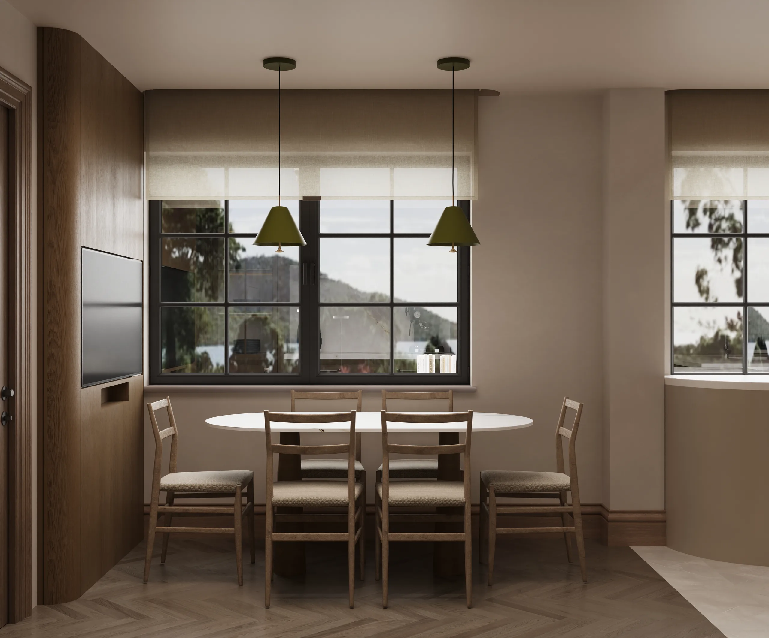 Kitchen dining nook with an oval table, olive green pendants and a wide window onto the water.