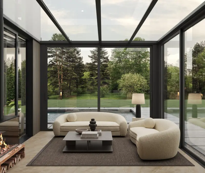 Glazed winter garden extension with a fireplace, bouclé seating and views over the lawn and pool.