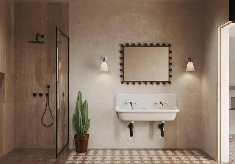 Bathroom with a cast-iron trough sink, a beaded mirror, a walk-in shower and patterned floor tiles.