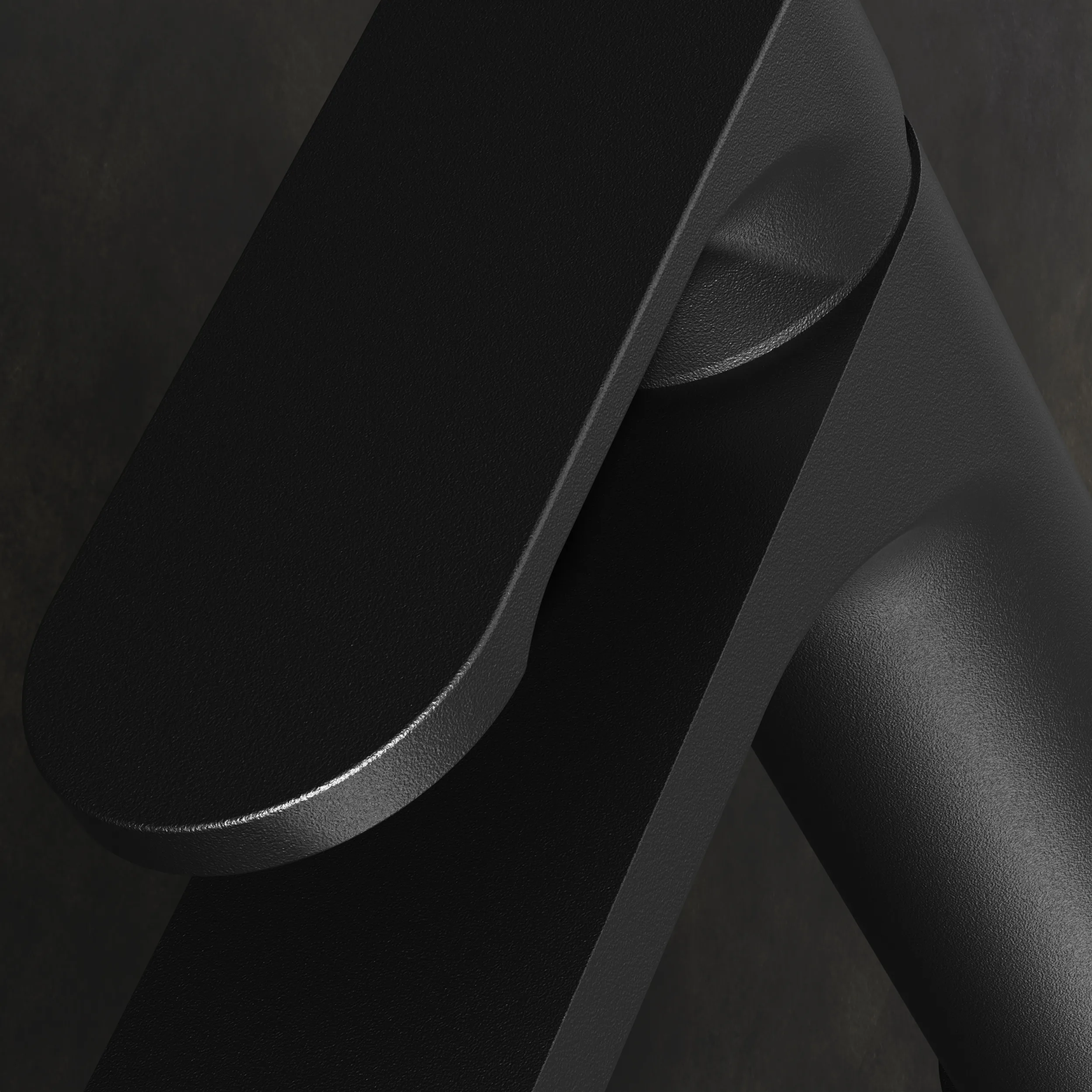 Macro study of a matt black tap lever and spout, lit to reveal the surface texture.
